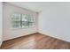 Bedroom with hardwood flooring, large window, and ample natural light at 7922 S Algonquian Way, Aurora, CO 80016