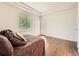 Bedroom featuring hardwood floors, a tray ceiling, and a door to the outside at 7922 S Algonquian Way, Aurora, CO 80016