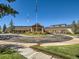 Exterior view of the community clubhouse showing well-maintained landscaping and ample parking at 7922 S Algonquian Way, Aurora, CO 80016
