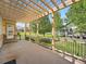 Inviting covered patio featuring a pergola, iron railing, and a view of the spacious backyard at 7922 S Algonquian Way, Aurora, CO 80016