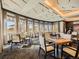 Elegant dining room featuring multiple tables, chairs, and natural light from the surrounding windows at 7922 S Algonquian Way, Aurora, CO 80016