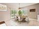 Stylized dining room featuring a dining table with seating for six, modern chandelier, and tile flooring at 7922 S Algonquian Way, Aurora, CO 80016