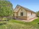 House exterior and pergola with mature trees surrounding the property at 7922 S Algonquian Way, Aurora, CO 80016