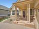 Covered front porch with brick accents, creating a welcoming entrance at 7922 S Algonquian Way, Aurora, CO 80016