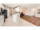 Open kitchen and living area with a breakfast bar, white cabinets, and stainless steel appliances at 7922 S Algonquian Way, Aurora, CO 80016
