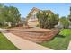 Beautifully landscaped yard with a retaining wall and mature shrubbery at 7922 S Algonquian Way, Aurora, CO 80016