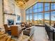 Comfortable lounge area featuring a stone fireplace, ample seating, and large windows at 7922 S Algonquian Way, Aurora, CO 80016