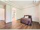 Hardwood floors and arched ensuite bathroom access are highlights of this main bedroom at 7922 S Algonquian Way, Aurora, CO 80016