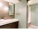 Modern bathroom featuring sleek vanity, unique lighting, and a view of the shower at 101 S Humboldt St, Denver, CO 80209