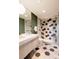 Elegant bathroom with decorative tile flooring, glass-enclosed shower, and modern vanity at 101 S Humboldt St, Denver, CO 80209