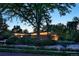 Serene evening view of a brick home featuring an expansive front yard and mature trees at 101 S Humboldt St, Denver, CO 80209