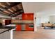 Modern kitchen features bright red cabinets, stainless steel appliances, and an open layout under striking staircase at 101 S Humboldt St, Denver, CO 80209