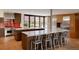 Modern kitchen with stainless steel appliances, red backsplash, seating, and view to the outside at 101 S Humboldt St, Denver, CO 80209