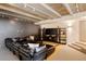 Modern living room featuring a sectional sofa, built-in shelving, and unique ceiling with track lighting at 101 S Humboldt St, Denver, CO 80209