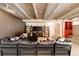 Open living room boasts a large sectional sofa, media center, and access to the stairs at 101 S Humboldt St, Denver, CO 80209