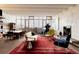 Bright living room with large windows, piano, fireplace, hardwood floors, and stylish modern furniture at 101 S Humboldt St, Denver, CO 80209