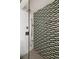 Contemporary shower with stylish patterned tile accent wall, and modern fixtures and showerhead at 101 S Humboldt St, Denver, CO 80209
