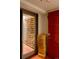 Walk-in wine cellar provides storage for a vast collection, adjacent to a contemporary red door at 101 S Humboldt St, Denver, CO 80209