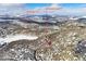 Aerial view of Evergreen Lake and town nestled among snow-covered mountains and trees at 4888 Silver Spruce Ln, Evergreen, CO 80439