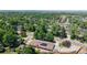 Beautiful aerial shot showcases the community's lush trees, pool, tennis courts, and solar panels at 11542 W 29Th Pl, Lakewood, CO 80215