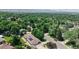 Beautiful aerial view showcases the home surrounded by lush greenery and a well-manicured yard at 11542 W 29Th Pl, Lakewood, CO 80215