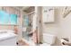 Bright bathroom featuring a shower, toilet, vanity, granite countertop, and framed window at 11542 W 29Th Pl, Lakewood, CO 80215