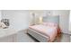 Bright bedroom featuring a bed with gray headboard, pink comforter, and a double door closet at 11542 W 29Th Pl, Lakewood, CO 80215