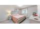Cozy bedroom featuring a comfortable bed and a window for natural light at 11542 W 29Th Pl, Lakewood, CO 80215