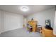 Bedroom with a gray carpet, a closet, a light and a wooden desk at 11542 W 29Th Pl, Lakewood, CO 80215