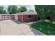 Side view of brick home featuring a well-manicured lawn, mature trees and a matching storage shed at 11542 W 29Th Pl, Lakewood, CO 80215