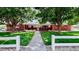 Charming brick home featuring a lush, green lawn and mature trees at 11542 W 29Th Pl, Lakewood, CO 80215