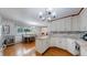 Bright kitchen with granite countertops, white cabinets, a dining table, and hardwood floors at 11542 W 29Th Pl, Lakewood, CO 80215