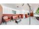 Covered outdoor patio with seating, brick accents, and a well-maintained concrete floor at 11542 W 29Th Pl, Lakewood, CO 80215