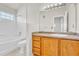 Well-lit bathroom features a bathtub, tiled walls, and wooden vanity with sink at 3261 S Waco Ct # C, Aurora, CO 80013