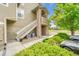 Side exterior featuring staircase with stone accents and green bushes at 3261 S Waco Ct # C, Aurora, CO 80013