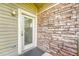 Close up of front door with stone accent wall and exterior light fixture at 3261 S Waco Ct # C, Aurora, CO 80013