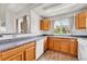 Bright kitchen features wood cabinets, tile flooring, and large windows for natural light at 3261 S Waco Ct # C, Aurora, CO 80013