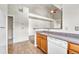 Open concept kitchen with wooden cabinetry, white appliances, and access to living area at 3261 S Waco Ct # C, Aurora, CO 80013