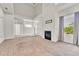 Spacious open-concept living room with fireplace, bright white walls, and large window at 3261 S Waco Ct # C, Aurora, CO 80013