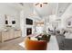 Beautifully staged living room featuring fireplace and open layout to kitchen and dining area at 3261 S Waco Ct # C, Aurora, CO 80013
