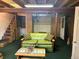 Relaxing basement space with comfortable seating and a staircase to the first floor at 4393 Pima Rd, Indian Hills, CO 80454