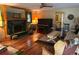 Inviting living room featuring a fireplace, wooden floors, piano and lots of natural light at 4393 Pima Rd, Indian Hills, CO 80454