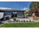 Well-maintained backyard with a concrete patio, hot tub, garden beds, and an outdoor seating area with an umbrella at 4930 Gray St, Denver, CO 80212