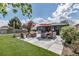 Spacious backyard patio with a dining set, outdoor grill, and hot tub, ideal for relaxation at 4930 Gray St, Denver, CO 80212