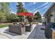 Backyard patio with comfortable seating, an umbrella, and a grill; perfect for outdoor entertaining at 4930 Gray St, Denver, CO 80212