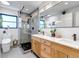 Modern bathroom with double vanity, glass shower, updated lighting, and elegant finishes at 4930 Gray St, Denver, CO 80212