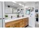 Elegant bathroom with double sink vanity, large mirror, stylish lighting, and modern fixtures at 4930 Gray St, Denver, CO 80212