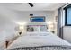 Inviting bedroom featuring neutral tones, soft lighting and a comfortable bed for a relaxing atmosphere at 4930 Gray St, Denver, CO 80212