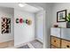 Stylish entryway featuring hats on hooks, wood floors, and a sleek storage cabinet at 4930 Gray St, Denver, CO 80212