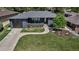 Charming single-story home featuring a landscaped front yard and a modern gray brick exterior at 4930 Gray St, Denver, CO 80212
